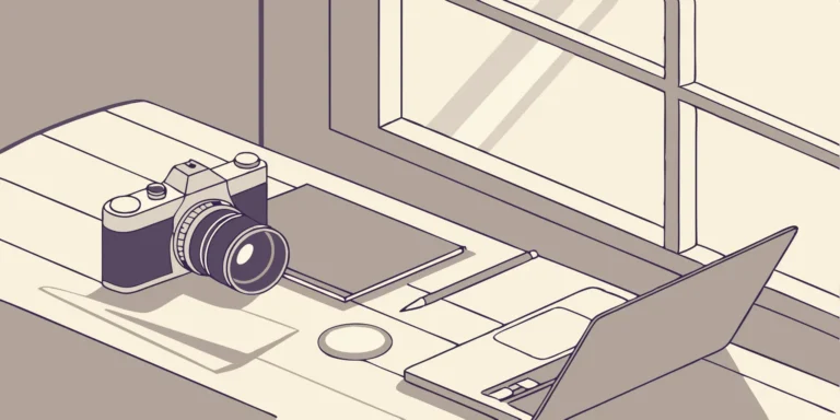 Photographer's affordable tax planning tools: Camera, laptop, and notebook.