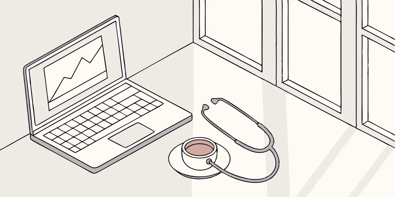 Stethoscope, laptop, and coffee cup on a desk. Healthcare worker tax preparation tools.