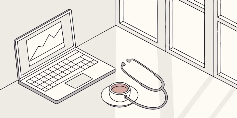Stethoscope, laptop, and coffee cup on a desk. Healthcare worker tax preparation tools.
