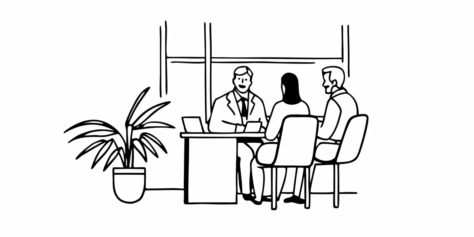 Financial advisor talking with a physician couple about retirement planning in a bright office